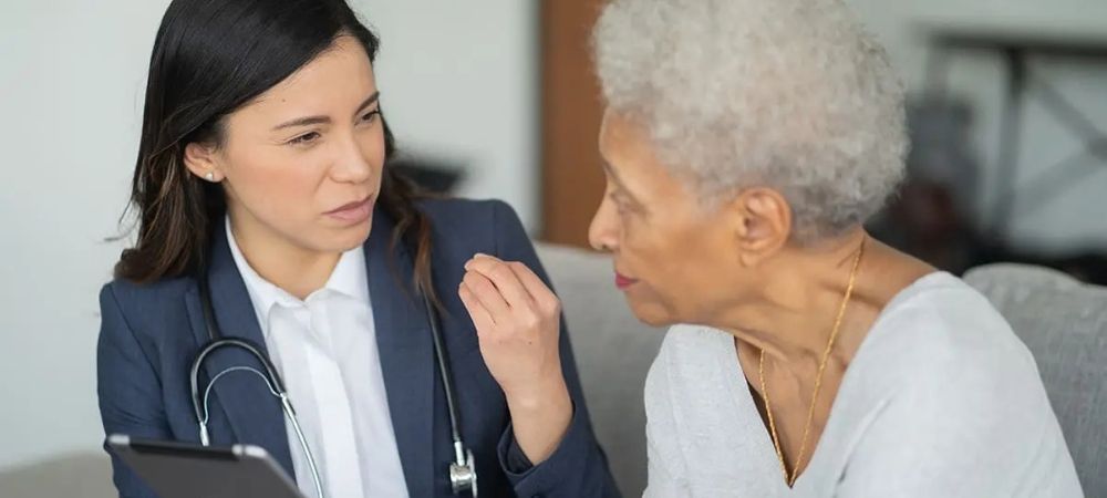doctor talking to older woman