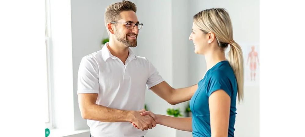 clinician shaking hands with a patient