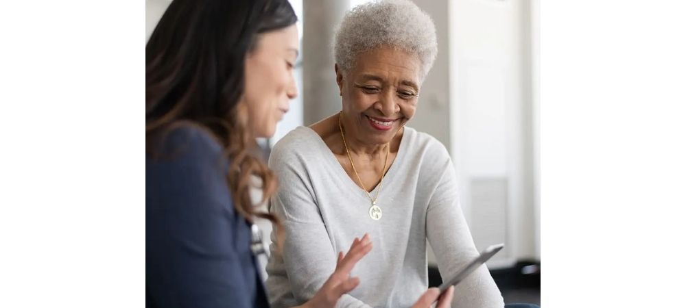 woman holding a phone talking to an older woman